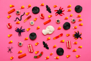 Wall Mural - Composition with sweet jelly candies and decor for Halloween on pink background