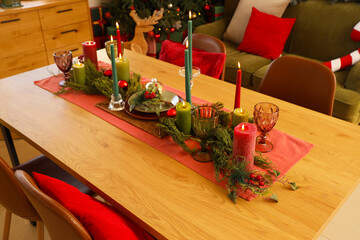 Wall Mural - Dining table set for Christmas with burning candles in room