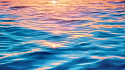 Blue ocean at sunset, warm colors reflecting,