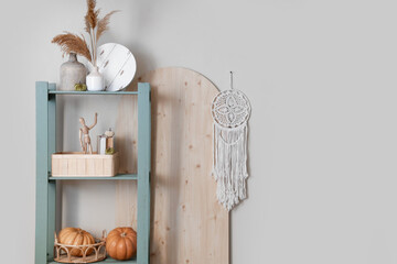 Sticker - Shelf unit with books and pumpkins near light wall in room