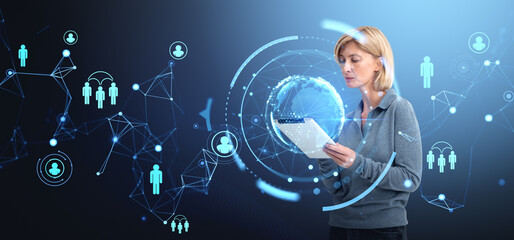Fototapete - Woman using a tablet surrounded by digital network holograms and