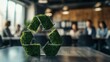 © kriengsak - Green Recycle Symbol on Wooden Table with Blurred Office Background