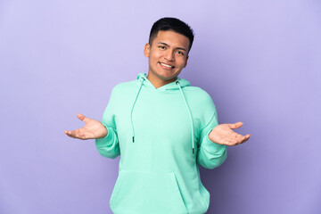 Young Ecuadorian man isolated on purple background happy and smiling