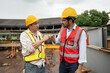 © chachamp - Asia engineer man worker fist bump with India engineer man with crane background