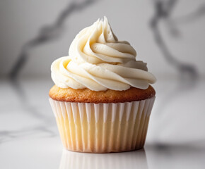 vanilla cupcake with creamy frosting on white background