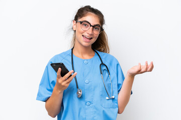 Wall Mural - Young nurse doctor woman isolated on white background keeping a conversation with the mobile phone with someone