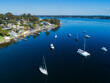 © Austockphoto - Aerial view of recreational boats in water of Lake Macquarie beside waterfront housing