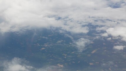 Wall Mural - view from plane over blue sky with white Fluffy clouds while flying through in sunny summer time.
