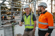 © Austockphoto - Construction workers looking and talking at the construction site.