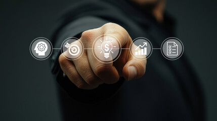 Businessman’s hand reaching out to interact with virtual icons representing key business concepts. 