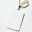 © VISUAL BACKGROUND - A white price tag tied with a string on a white surface
