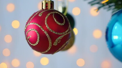 Wall Mural - Christmas tree decorated with red ball on pine branches with bokeh light background