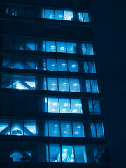 Poster - Office building with neon light at night overtime work Business background