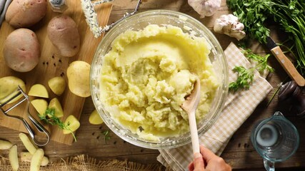 Canvas Print - Woman’s Hand with Wooden Spoon in Bowl of Mashed Potatoes – Cooking and Preparation Concept