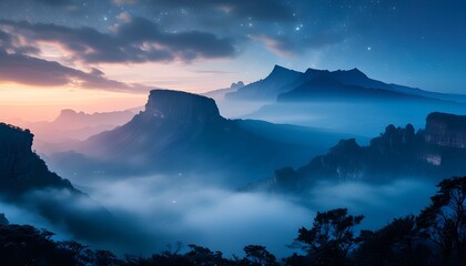 Mystical blue mountain landscape enveloped in mist beneath a serene night sky