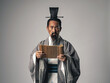 © metamorworks - 三国志に登場する諸葛孔明のような中国歴史上の人物が竹簡に書かれた文字を読むシーン