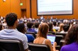 © Natalia - A group of diverse university students attentively listen to a lecture in a large hall.
