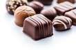 © Dzikrul Husnani - chocolate candy close up on a white , ai