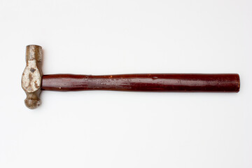 An old rusty hammer. This hammer with a wooden handle is usually used to drive nails, both large and small.