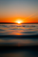 Wall Mural - beautiful sunrise view from the ocean water surface.