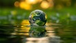 © ifoto - A glass sphere containing the earth floats on water against a green background with blurred surroundings
