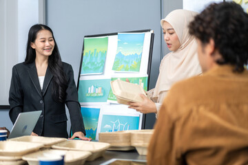 Diverse team professionals collaborating on sustainable development project during a corporate meeting, presentation eco-friendly designs with charts and data on renewable energy and green technology