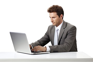 A top executive sitting at a desk and working on a laptop