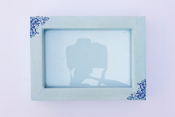 A blue photo frame, designed to accent your space with a consistent coastal style, featuring soft, calming tones like light blue.