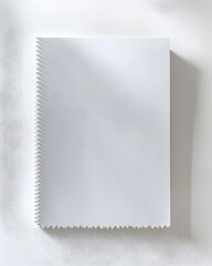 Poster - Crisp White Notepad Showcased Against Clean White Backdrop for Modern Office Aesthetic