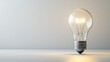 © arthit - Side view of a light bulb with a bright, clean background, offering ample copy space on the left side for text or logos.