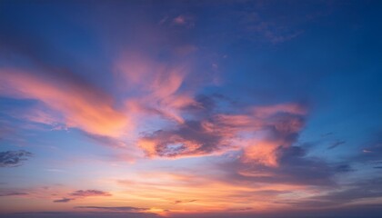 The image depicts a serene cloudscape at sunset in the sky. 