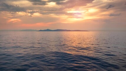 Wall Mural - Aerial flight or captains boat POV over the calm ocean into the golden summer sunset