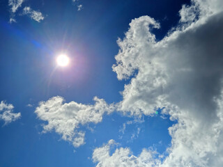 White cumulus clouds in the summer sky background