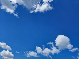 White cumulus clouds in the summer sky background