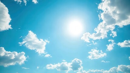 Bright Blue Sky with Fluffy White Clouds and Radiant Sunlight on a Clear Day