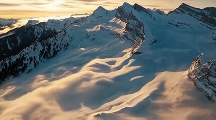 Poster -   A stunning aerial shot of a snow-capped mountain range with lush trees framing the base