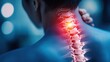 © JoxyAimages - A person is shown from behind with a highlighted area on their cervical spine, indicating pain or a medical condition affecting the neck vertebrae in a blue toned image.