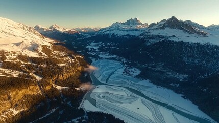 Wall Mural -   An aerial view of a mountain range with a river in the foreground and snow-capped mountains in the background