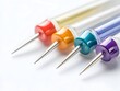 © Bos Amico - Colorful Push Pins with Decorative Metallic Tips on White Background