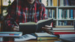© Swaroop - Student studying with books and a laptop at a desk – focused student reading a book, laptop and notebooks on the desk, clean and modern study space.