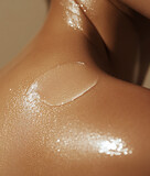 Beautiful female neck with moisturizing cream on the shoulder, close-up	