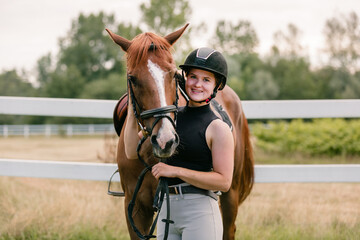 Female rider hand gently caressing beautiful thick red horse mane, close up shot. Equitation and animal lover concept.