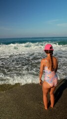 Wall Mural - A Girl Enjoying a Beautiful Day at the Beach, Experiencing Adventure and Fun in the Sun