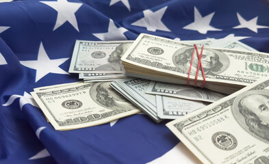 Wall Mural - One hundred dollars banknotes on flag background