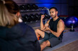 © SKW - Asian man and woman working out, one is a trainer, the other is an exerciser.