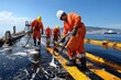 © Sasint - An oil spill containment operation in progress, with specialized equipment and workers mitigating the environmental impact, emphasizing the industry's response to ecological risks