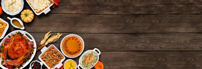 Poster - Traditional Thanksgiving turkey dinner. Above view corner border on a rustic dark wood banner background. Turkey, mashed potatoes, stuffing, casseroles, pumpkin pie and sides.