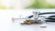 © อาริษา วันดี - Stethoscope on Coins Representing Healthcare Costs