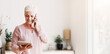 © Prostock-studio - Busy senior woman consulting client on phone and reading contract on digital tablet at home, copy space