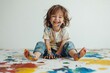 © Minerva Studio - Happy child covered in paint smiling while playing
